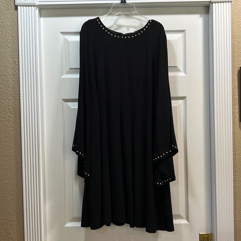 Emma Michelle extra large black dress gold studs around neck and end of sleeves.
